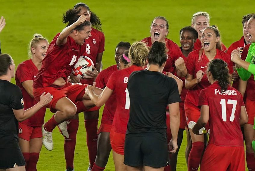 Canada players, including Christine Sinclair, celebrate their win against Sweden during the women's soccer gold medal game at the Tokyo Olympics in Yokohama, Japan on Friday, August 6, 2021.