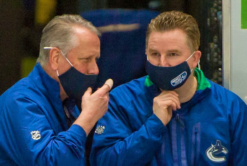 Vancouver Canucks Equipment Manager Pat O'Neill (left) and Brian Hamilton, Assistant Equipment Manager prior to playing Ottawa Senators in NHL hockey at Rogers Arena in Vancouver, BC, January 27, 2021. Hamilton discovered a malignant melanoma on his neck after a Seattle Kraken fan got his attention during an October NHL game.
