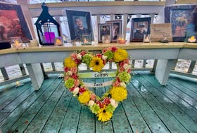 A wreath of flowers, candles and photographs adorned the gazebo at Frost Park in Yarmouth on Jan. 9 for a candlelight vigil to celebrate the birthdays of Colton Cook and Zack Lefave. TINA COMEAU PHOTO