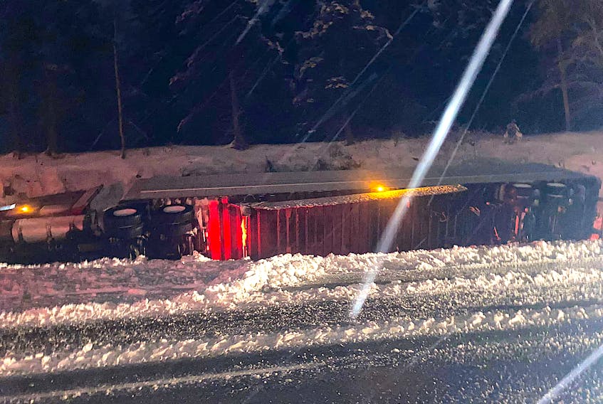 A transport truck is on its side on Highway 105 in Boularderie East near the Seal Island Bridge Sunday evening. Nova Scotia RCMP say roads were icy at the time of the incident. Contributed • April Leamon