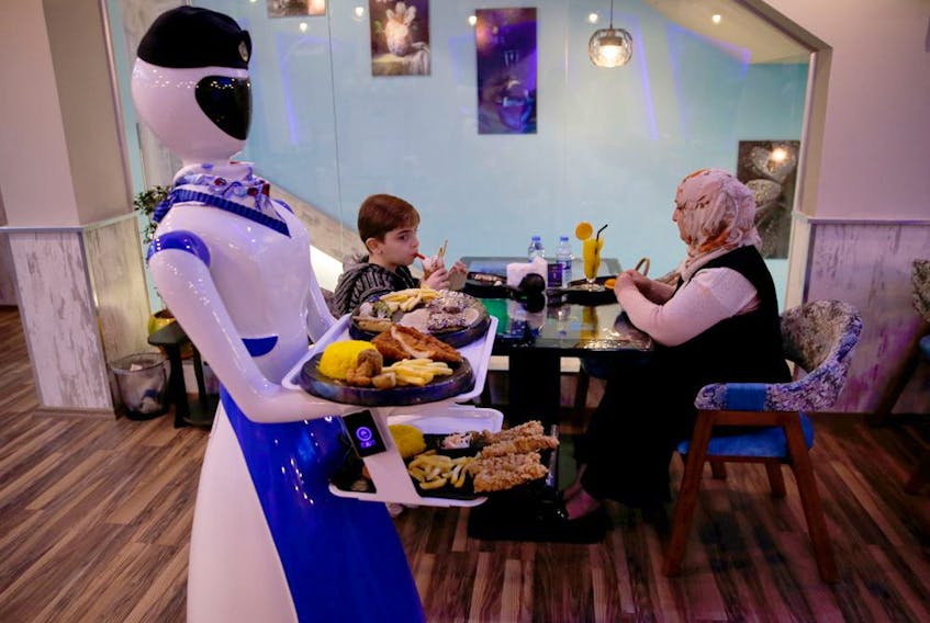 Robots deliver food to customers at a restaurant which recently opened in the city of Mosul, Iraq, November 16, 2021. Artificial intelligence is expected to grow at 20 per cent a year to US$90 billion by 2025, suggesting a 2.5 times expansion over the next five years.