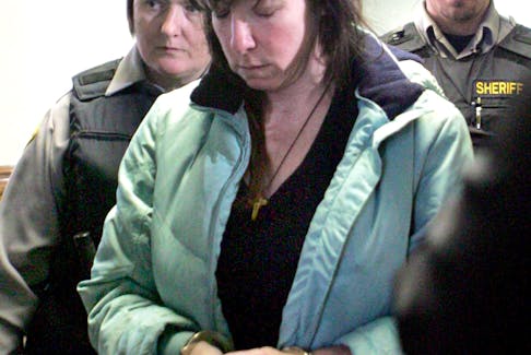 Penny Boudreau is escorted out of the Bridgewater Courthouse on Friday, Jan. 30, 2009 after pleading guilty to second-degree murder in the death of her 12-year-old daughter Karissa.