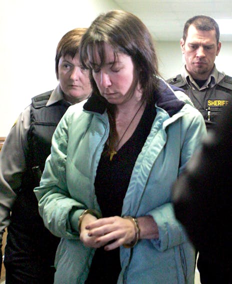 Penny Boudreau is escorted out of the Bridgewater Courthouse on Friday, Jan. 30, 2009 after pleading guilty to second-degree murder in the death of her 12-year-old daughter Karissa.
