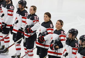 Team Canada players, including Marie-Philip Poulin, Rebecca Johnston and Natalie Spooner, lineup before an exhibition game against the U.S. in Missouri on Dec. 15. - JONATHAN ERNST / REUTERS