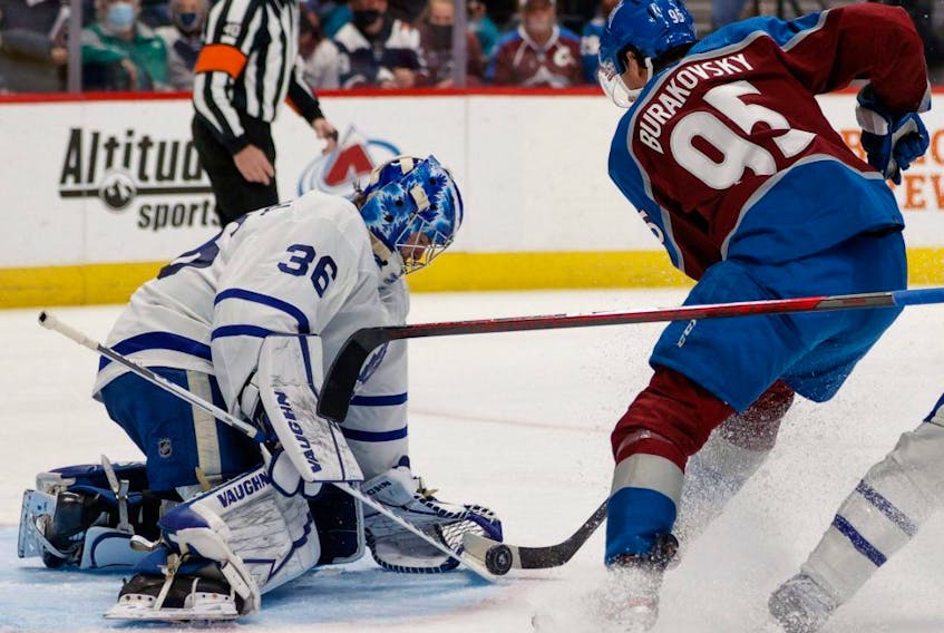 Maple Leafs goaltender Jack Campbell makes a save against Avalanche left wing Andre Burakovsky during NHL action at Ball Arena in Denver, Saturday, Jan. 8, 2022.
