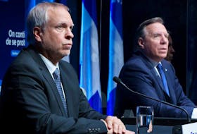 Dr. Luc Boileau, interim Quebec Director of Public Health and Quebec Premier Francois Legault during a news conference in Montreal, Tuesday, Jan. 11, 2022. THE CANADIAN PRESS/Paul Chiasson