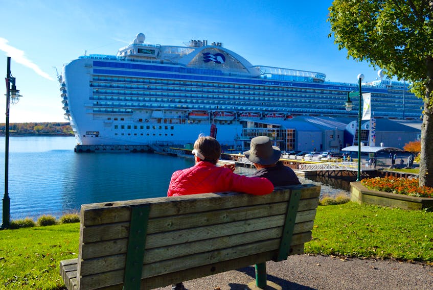 Cruise ship passengers enjoy a minutes on a Sydney boardwalk bench before returning to their vessel during a November 2017 visit to the Cape Breton port. DAVID JALA/CAPE BRETON POST