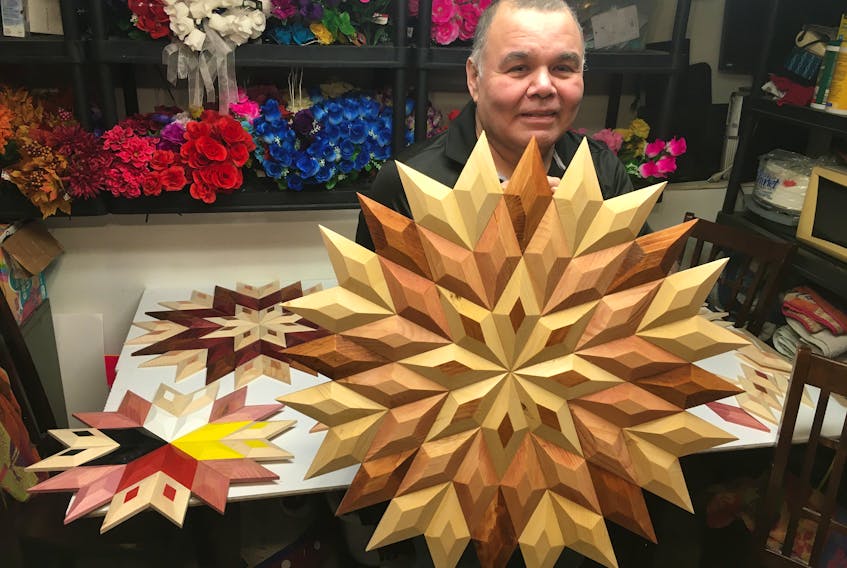 Eskasoni woodworker Stephen Francis used his passion for math to create these intricate Mi'kmaw eight-point stars. A piece similar to the one he is holding here is on its way to California, where it will make an appearance in an upcoming episode of the sitcom Rutherford Falls starring Ed Helms. ARDELLE REYNOLDS/CAPE BRETON POST