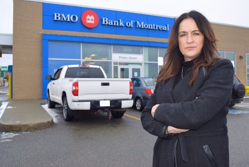 Heidi McNeil of Mira stands in front of the Bank of Montreal on Prince Street in Sydney. McNeil said she is a victim of fraud, it has turned her life upside down and she doesn’t plan to stop until the culprits responsible are apprehended and charged.  Sharon Montgomery-Dupe/Cape Breton Post