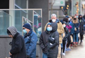 People line up at the Halifax Convention Centre Dec. 21, 2021. Many lined up to accept COVID-19 rapid test kits. But health officials also provided PCR testing. 