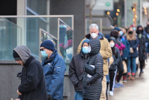 People line up at the Halifax Convention Centre Dec. 21, 2021. Many lined up to accept COVID-19 rapid test kits. But health officials also provided PCR testing. 