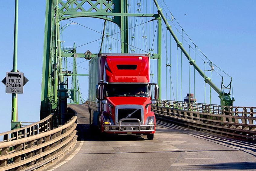  A transport truck enters Ontario over the Thousand Islands Bridge from the United States, in June 2021.