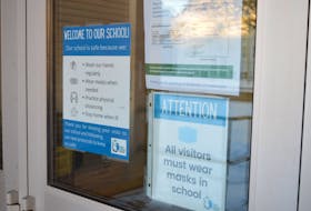 Public health reminders are posted to the front doors at St. Jean Elementary School in Charlottetown.
