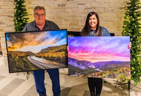 Stewart Foote (left) and his daughter, Crystal Green, display the two photos their family purchased in memory of his wife and her mother, Linda Foote, for the palliative care unit at the Western Long Term Care Home in Corner Brook. Before her death in October 2021, Linda Foote selected the photo her husband is holding to be placed in Room 317, the room she spent the last eight weeks of her life in. - Dru Kennedy Photo