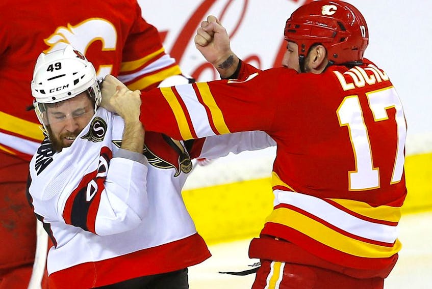  Senators winger Scott Sabourin fights with Flames winger Milan Lucic in the second period of Thursday’s game in Calgary.