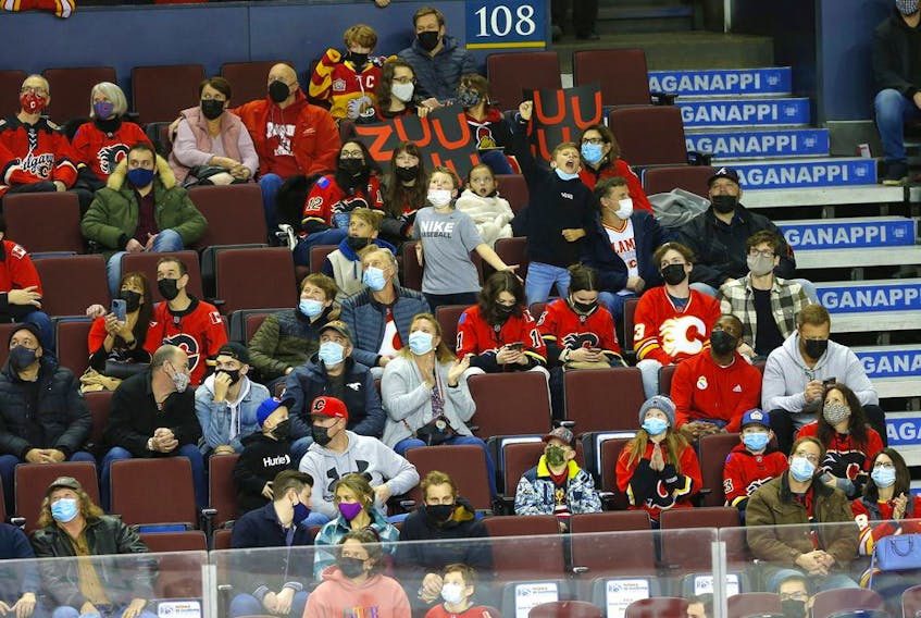  Fans attend the Calgary Flames-Ottawa Senators game at Scotiabank Saddledome in Calgary on Thursday, Jan. 13, 2022. The building was at half capacity due to Alberta restrictions.