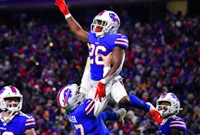 Bills running back Devin Singletary (top) celebrates with quarterback Josh Allen after scoring a touchdown against the Patriots on Saturday night. The Bills won 47-17.
