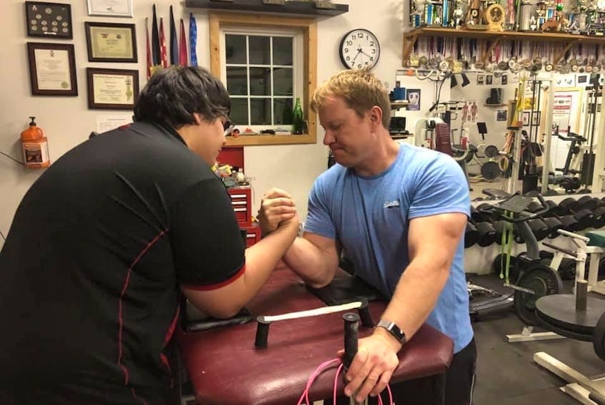 Mark MacPhail, right, competes in an armwrestling match with Liam Johnson during training at the Cape Breton Golden Arms Club. MacPhail will be one of the organizers when Cape Breton hosts the 2023 Canadian Armwrestling Championships in Membertou. PHOTO CONTRIBUTRED/MARK MACPHAIL. 