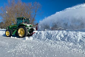 A tractor clears snow from the end of a driveway on County Line Road in Emerald on Jan. 16 as P.E.I. residents began the cleanup after the second winter storm of the year. 
