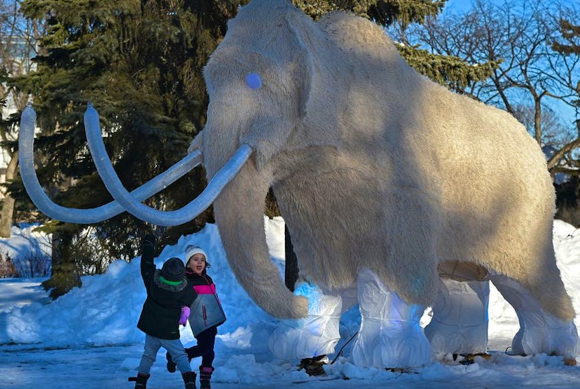 Siblings James, 3 and Georgia, 4, Miner check out the woolly mammoth on display at the 15th annual Deep Freeze: A Byzantine Winter Fête before the gates opened at 4pm which runs till January 23rd at Borden Park.