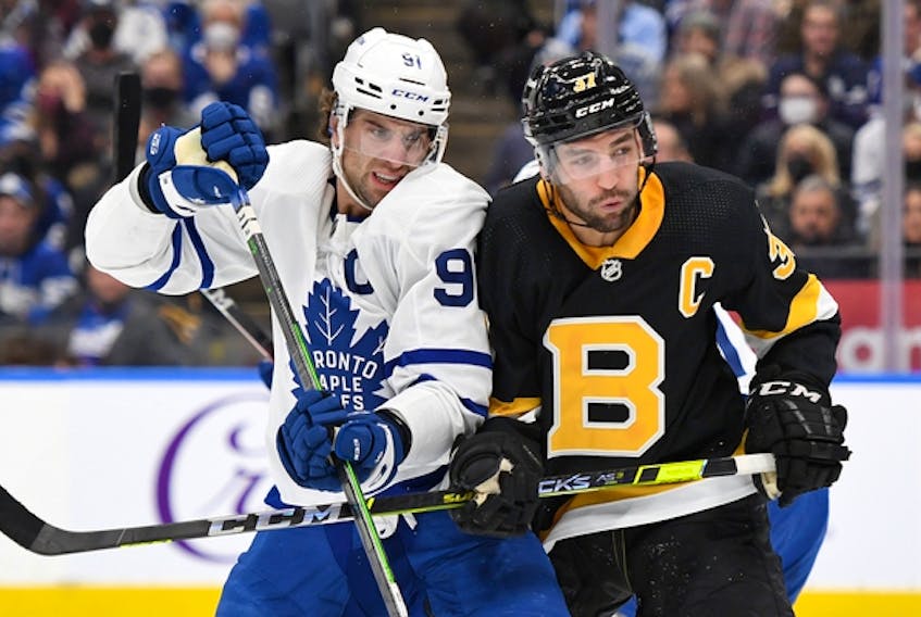 Maple Leafs captain John Tavares (left) battles for position with Boston Bruins counterpart Patrice Bergeron earlier this season. The Bruins are on a five-game winning streak and closing fast on the third-place Toronto in the Atlantic Division. 