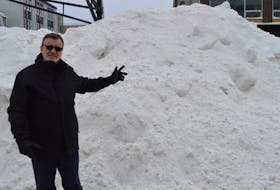 Coun. Terry MacLeod, chair of Charlottetown council’s public works committee, stands by a snowbank in the middle of Great George Street on Jan. 17.