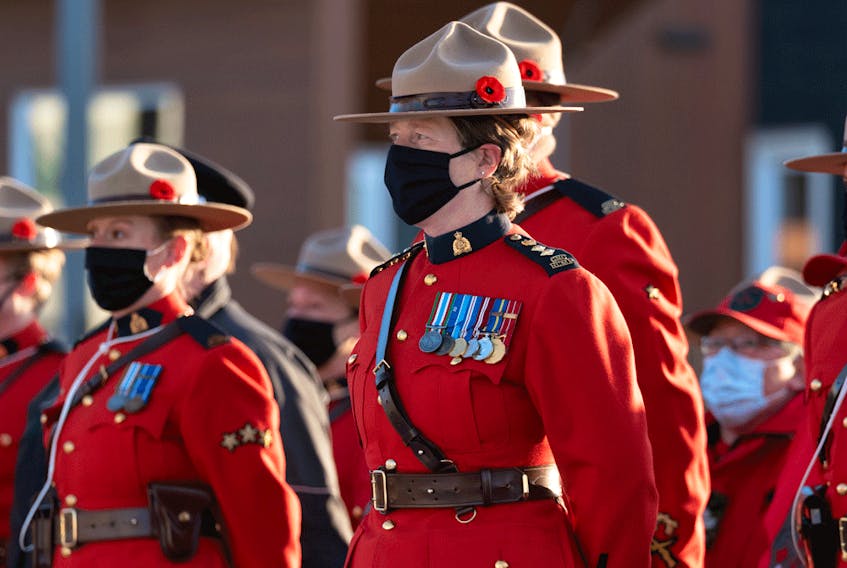 Members of the RCMP stand at attention during a Remembrance Day ceremony in Iqaluit, Nunavut, on November 11, 2021.