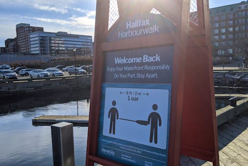 A sign on the Halifax waterfront promotes social distancing amid the COVID-19 pandemic. - File