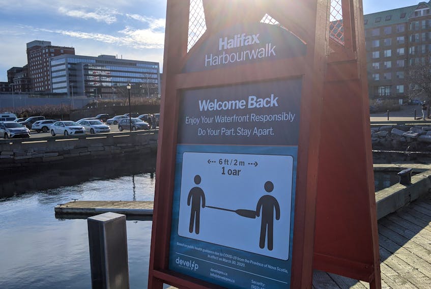 A sign on the Halifax waterfront promotes social distancing amid the COVID-19 pandemic. - File