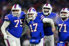 Buffalo Bills quarterback Josh Allen (17) celebrates after wide receiver Gabriel Davis (13) scores a touchdown during the second half of an NFL wild-card playoff football game against the New England Patriots, Saturday, Jan. 15, 2022, in Orchard Park, N.Y. 
