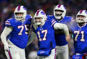 Buffalo Bills quarterback Josh Allen (17) celebrates after wide receiver Gabriel Davis (13) scores a touchdown during the second half of an NFL wild-card playoff football game against the New England Patriots, Saturday, Jan. 15, 2022, in Orchard Park, N.Y. 