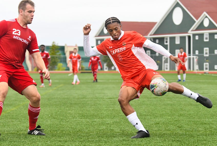 Cape Breton Capers forward Kairo Coore, right, prepares to kick the ball during Atlantic University Sport action against the Memorial Sea-Hawks at the Cape Breton Health Recreation Complex Turf in Sydney last season. Coore is one of 10 Capers players eligible for the Canadian Premier League-U Sports draft on Thursday. PHOTO CONTRIBUTED/VAUGHAN MERCHANT, CBU ATHLETICS
