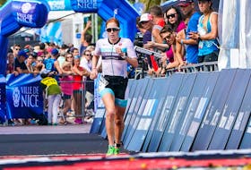 Paula Findlay of Edmonton crosses the finish line at the Ironman 70.3 Indian Wells La Quinta on Dec. 14, 2019.  