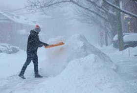 Edward Luff shovelling the snow on McGillivray St. Monday, January 17, 2022. 