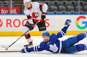  Drake Batherson of the Senators gets set to fire a puck away from a falling T.J. Brodie of the Maple Leafs.