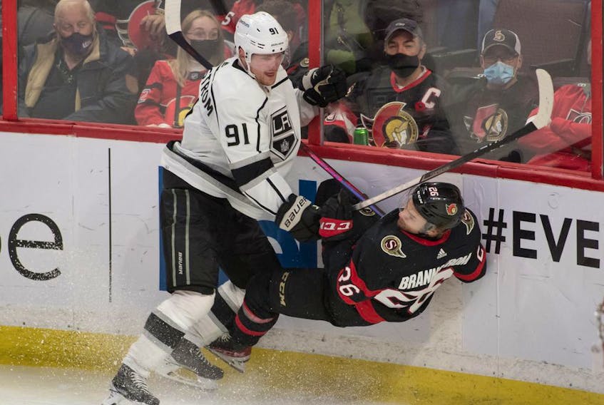  Senators defenceman Erik Brannstrom (26) is checked by Kings right-winger Carl Grundstrom in the third period of the Nov. 11 game at Canadian Tire Centre. Later in the period, Brannstrom’s left hand was broken when he was struck by the puck.