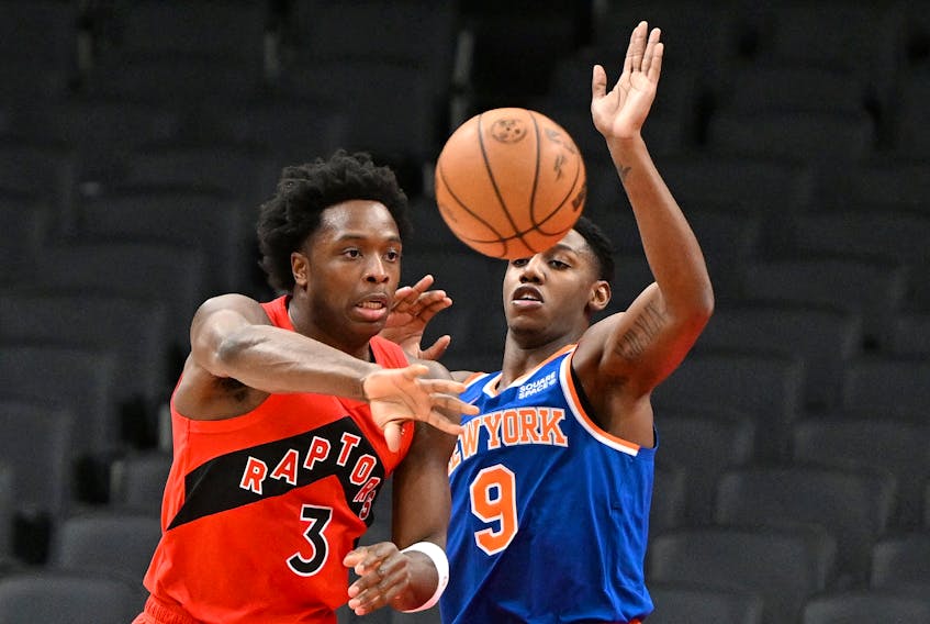 Raptors' OG Anunoby passes the ball away from New York Knicks' RJ Barrett during the first half at Scotiabank Arena on Sunday, Jan. 2, 2022. 