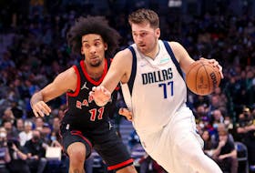 Dallas Mavericks' Luka Doncic drives to the basket as Toronto Raptors forward Justin Champagnie defends.