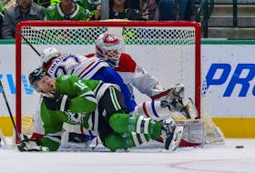 Dallas Stars' Joe Pavelski reacts to being checked as Montreal Canadiens' Alexander Romanov and goaltender Sam Montembeault defend during the third period at the American Airlines Center in Dallas on Jan. 18, 2022.
