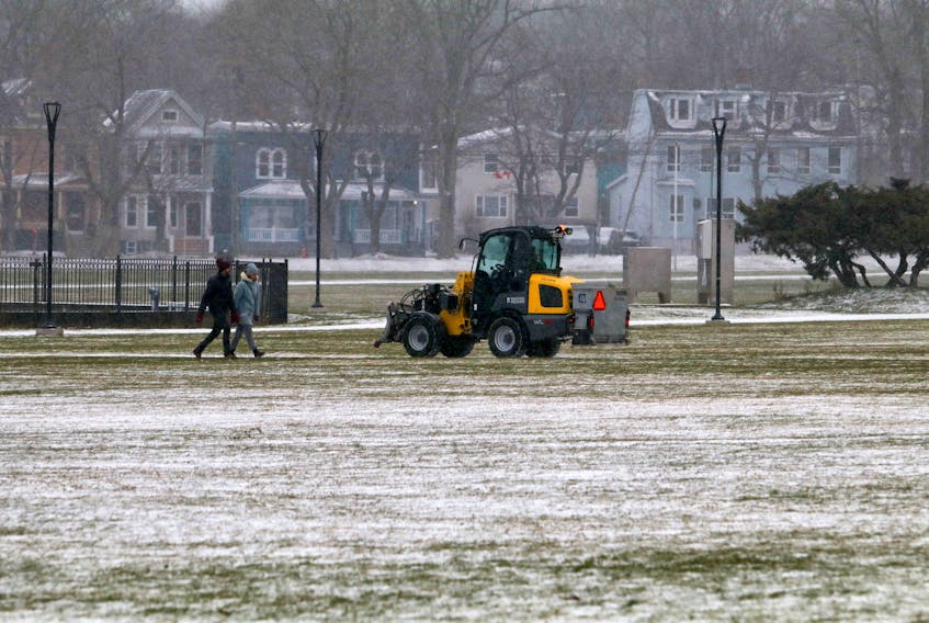 Dec. 17, 2020—Pedestrians take to one of the paths in the Halifax Common as a vehicle salts the walkways.
ERIC WYNNE/Chronicle Herald