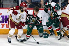 Halifax Mooseheads winger Zachary L'Heureux loses his helmet after a check from Bathurst Titan's Marc-Andre Gaudet during second period play on Dec. 16, 2021 at the Scotiabank Centre. L'Heureux was assessed a penalty for playing without a helmet. - Eric Wynne
