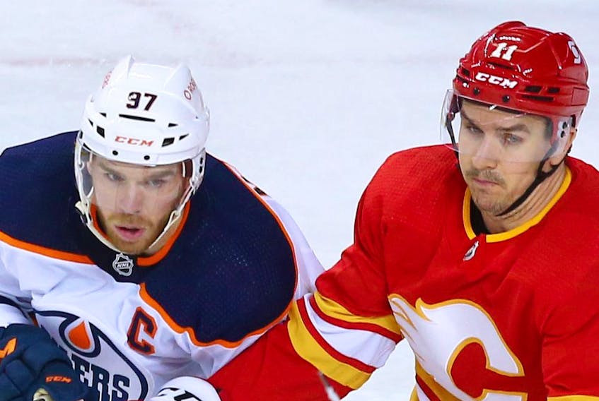 Flames forward Mikael Backlund keeps an eye on always-dangerous Edmonton Oilers captain Connor McDavid during action at the Scotiabank Saddledome in Calgary in this photo from April 10.