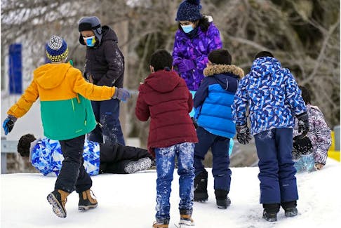 Children play in the school yard outside Garneau School in Edmonton on Thursday January 20, 2022.