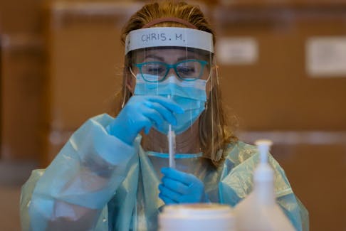 FOR COVID FILE:
Christina Murray, prepares a rapid test for a reading at a COVID19 rapid testing site at the Spring Garden Road Library Tuesday January 18, 2021.

TIM KROCHAK PHOTO