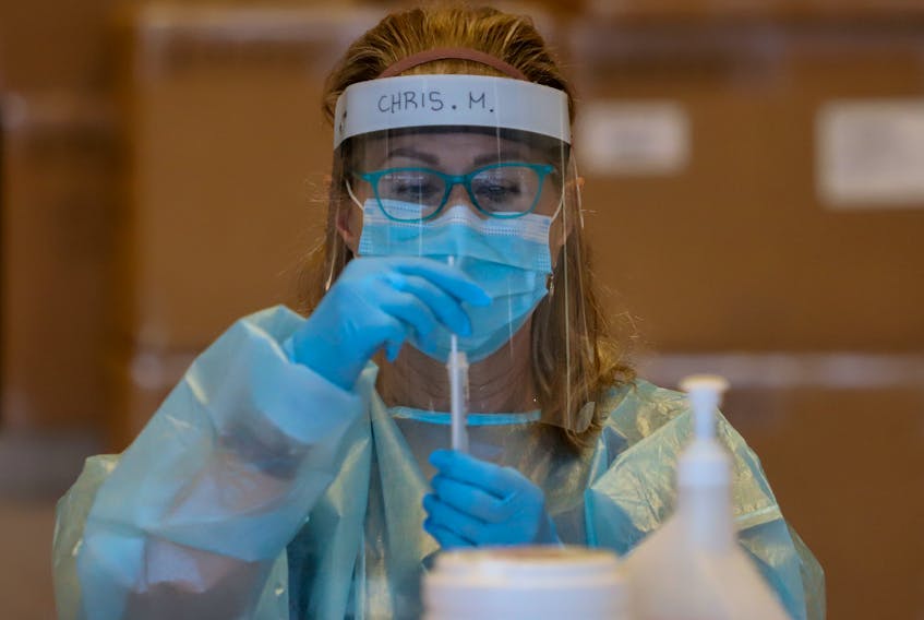 FOR COVID FILE:
Christina Murray, prepares a rapid test for a reading at a COVID19 rapid testing site at the Spring Garden Road Library Tuesday January 18, 2021.

TIM KROCHAK PHOTO