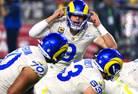 Matthew Stafford of the Los Angeles Rams calls a play at the line of scrimmage in the second quarter of the game against the Arizona Cardinals at State Farm Stadium on Dec. 13, 2021 in Glendale, Ariz.