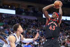 Toronto Raptors forward Pascal Siakam (right) shoots over Dallas Mavericks centre Dwight Powell during the second half of an NBA game on Jan. 19, 2022, at American Airlines Center.