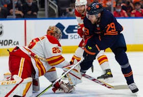 Edmonton Oilers' Leon Draisaitl (29) is stopped by Calgary Flames goaltender Jacob Markstrom (25) at Rogers Place in Edmonton on Oct. 16, 2021. 