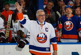 Former New York Islander Clark Gillies is honored prior to the game against the Chicago Blackhawks aat the Nassau Veterans Memorial Coliseum on December 13, 2014 in Uniondale, New York.  