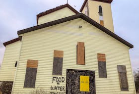 A contractor has put the words 'FOOD AND WATER INSIDE' on the outside of the St. Anthony's Church in Glace Bay, which is slated for demolition in late winter and has become the home of hundreds of pigeons and starlings. JESSICA SMITH/CAPE BRETON POST